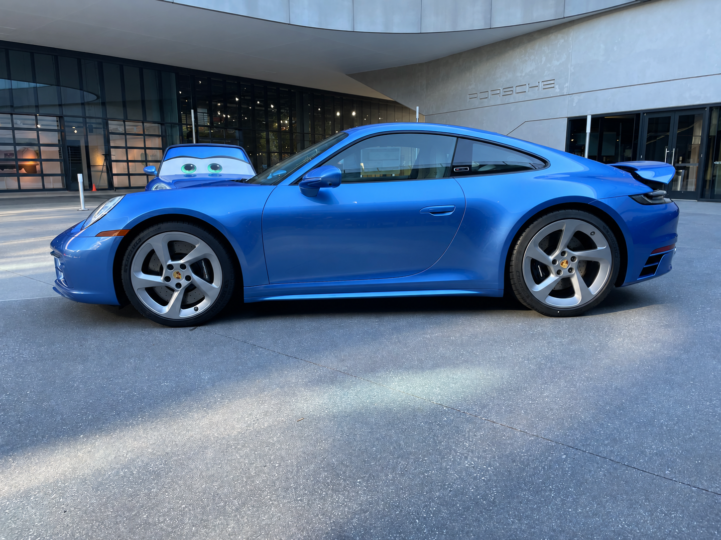 Sally Special outside the Porsche building, with the Sally character car behind it; people removed from the supplied photograph